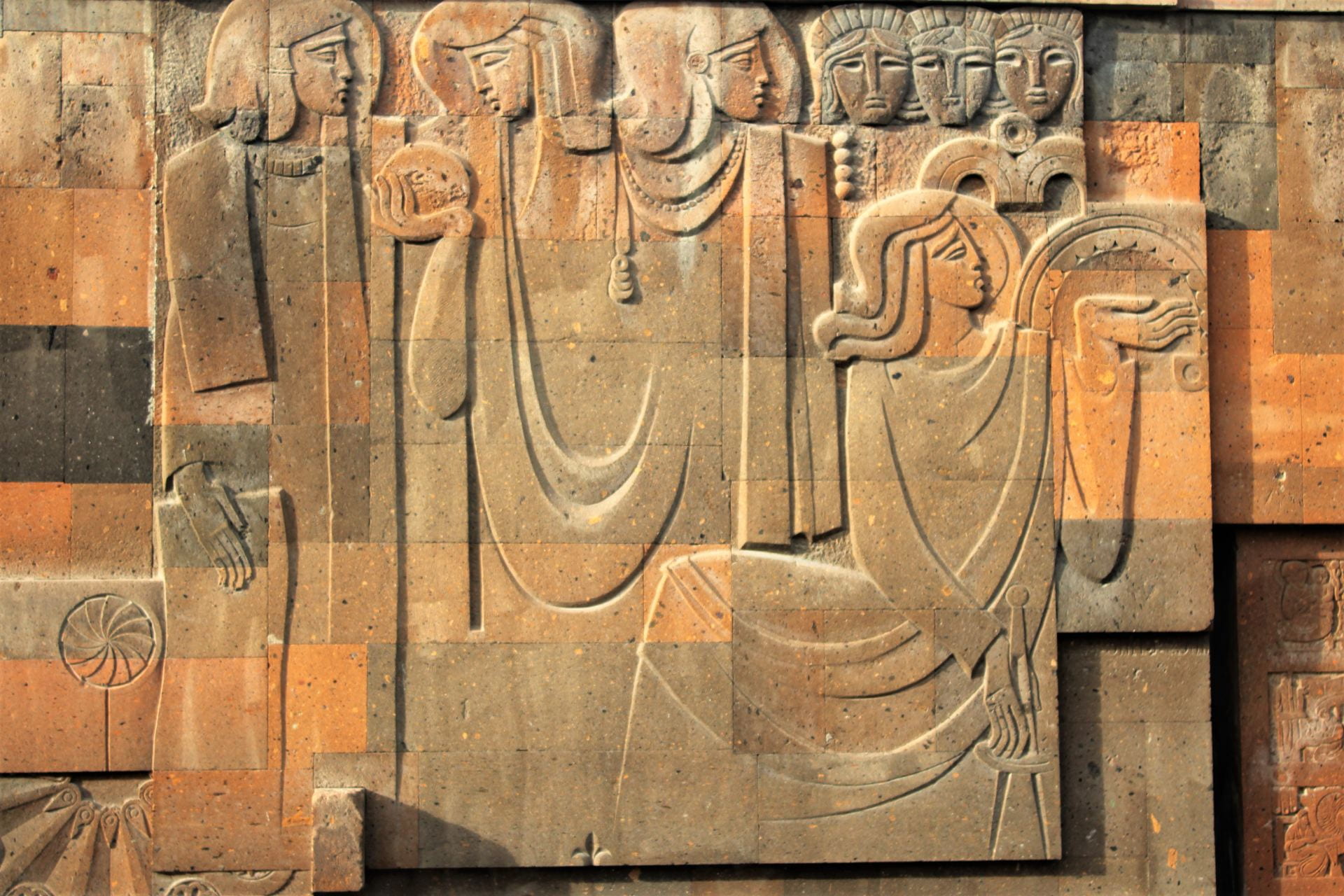 Memory Wall in Komitas Pantheon, Yerevan: Red tufa stones with four figures
