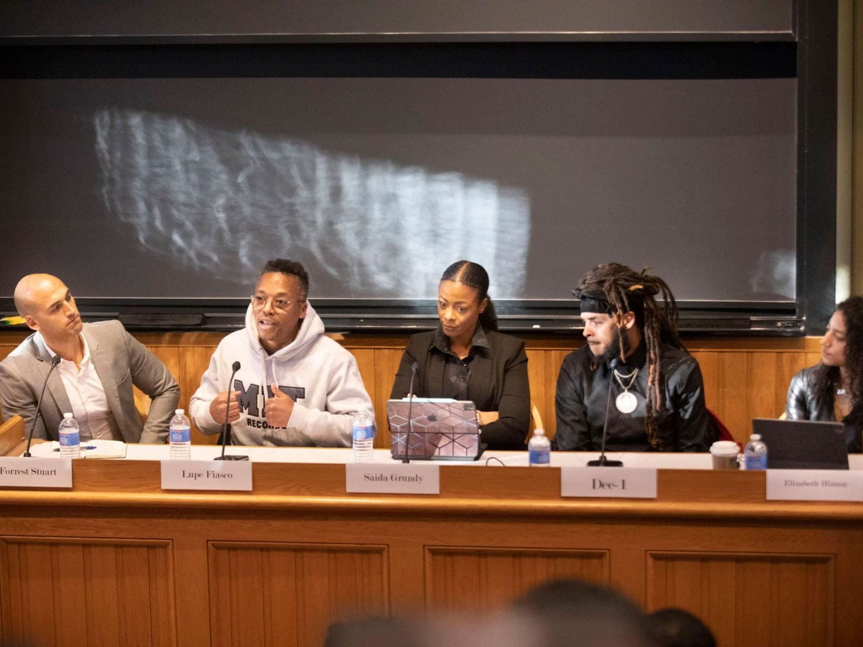 Photo of panelists - links to the Harvard Gazette