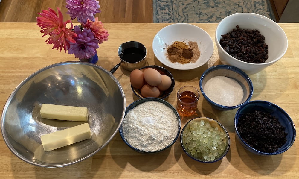 Ingredients for a quarter recipe of Emily Dickinson's Black Cake: butter, molasses, flour, eggs, spices, brandy, sugar, and dried fruit.