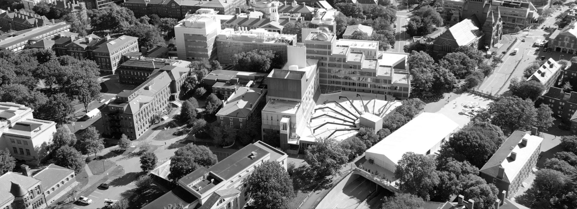 A black and white aerial view of the Harvard University Cambridge campus with a focus on the Science Center building.
