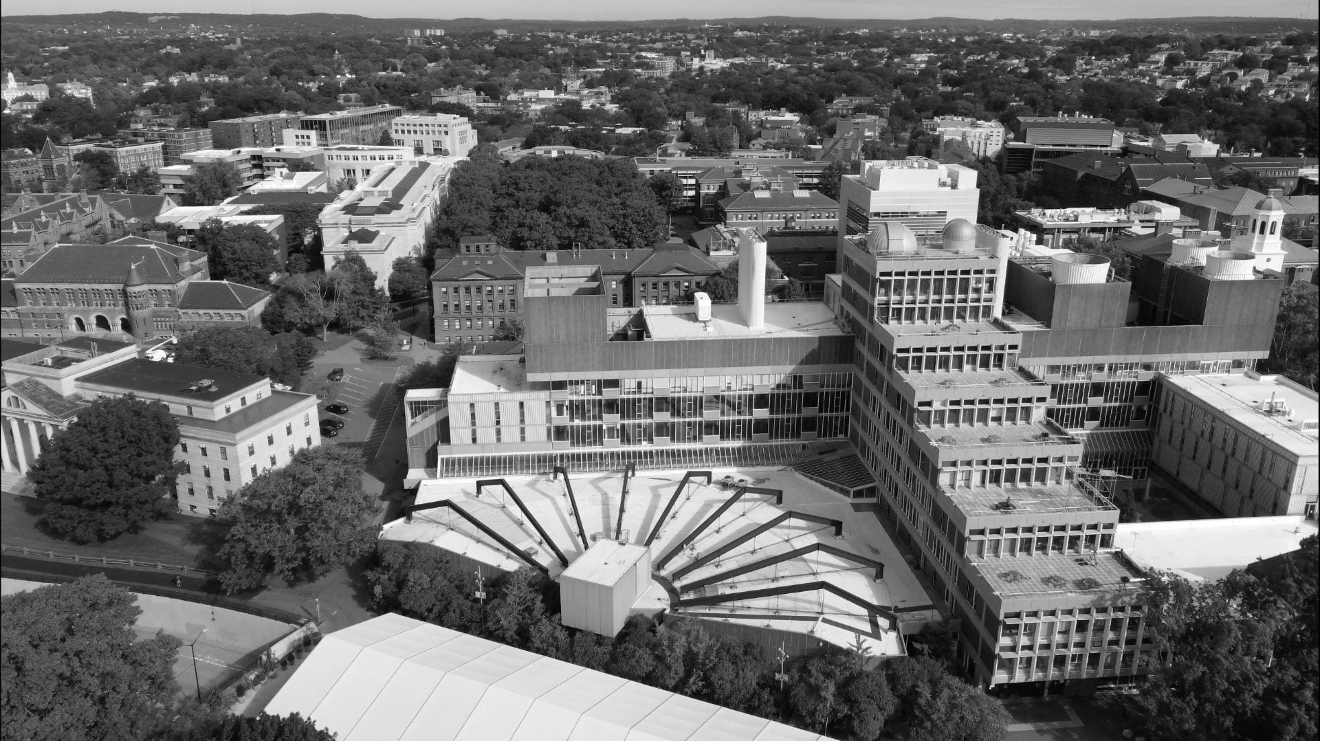 An aerial black and white photo of the Harvard University campus with a focus on the Science Center building.